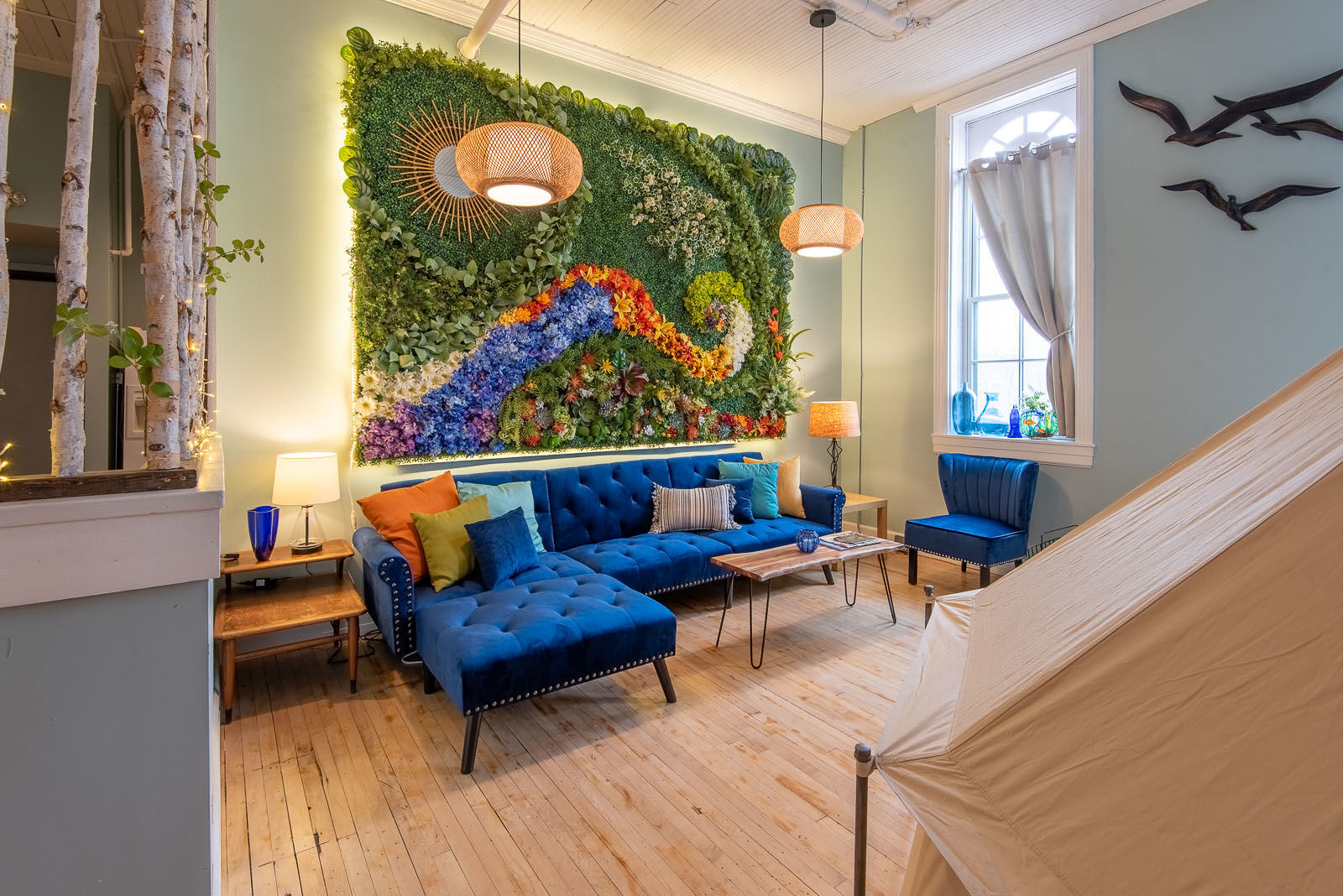 The indoor "glamping" lodging facility includes a living area and artwork